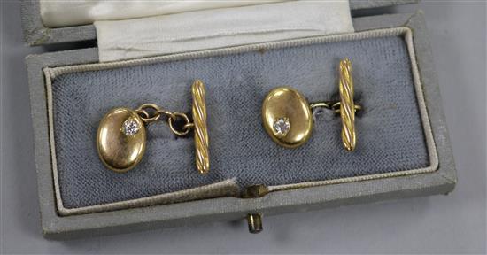 A cased pair of early 20th century high carat gold and diamond set oval cufflinks.